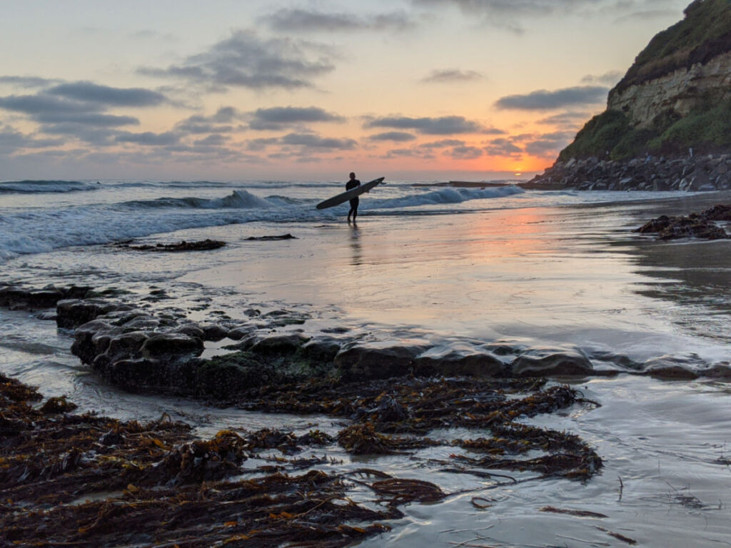 A surfer at Swami’s Beach in Encinitas
