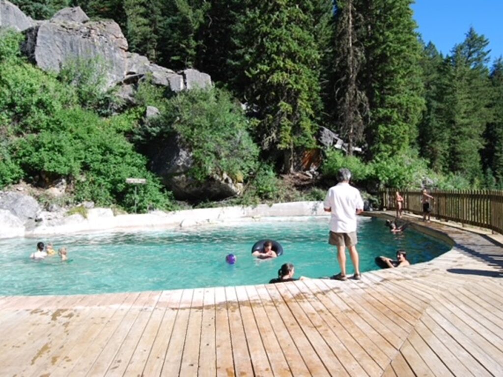 People swimming at the Granite Hot Springs on a sunny day