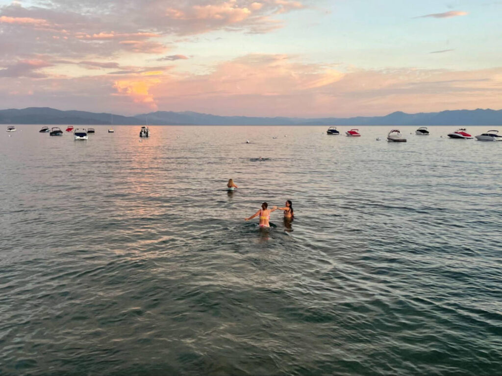 Overlooking view of the people swimming in Lake Tahoe at sunset