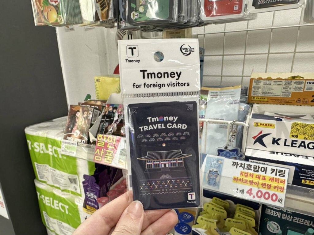 A hand holding a T-Money card inside the store