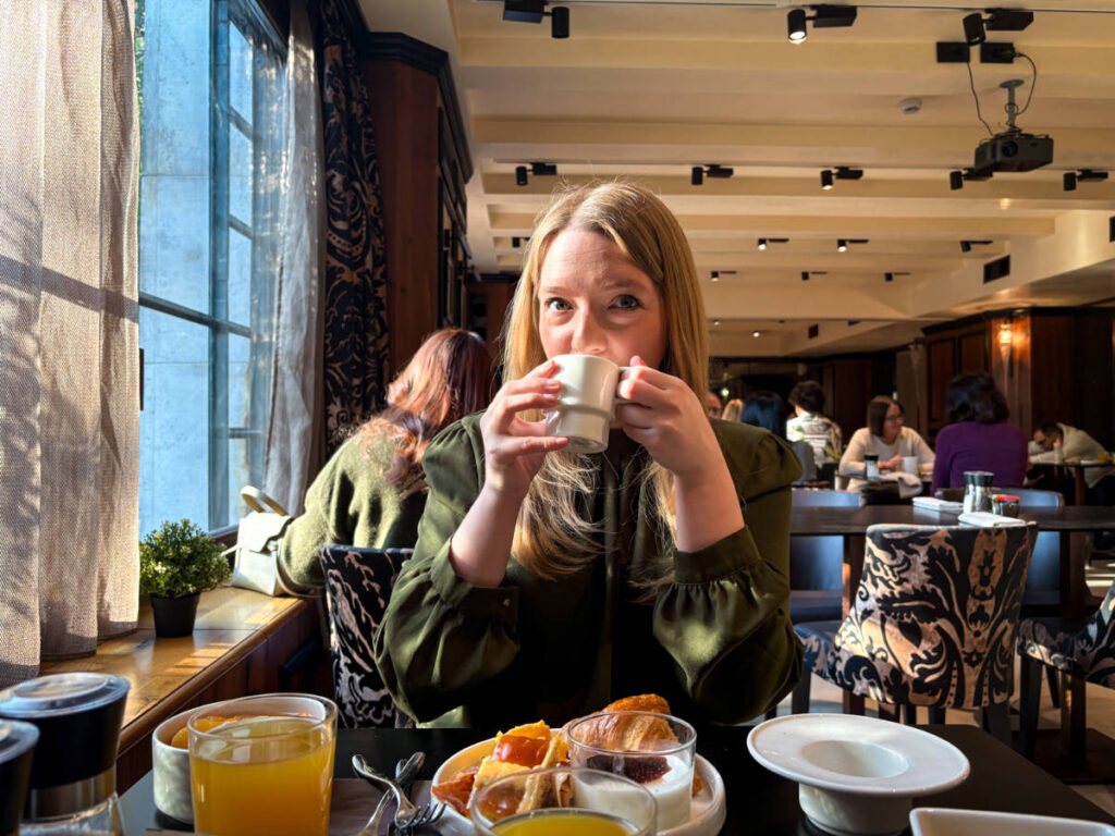 The author Taylor Herperger, enjoying a cup of cappuccino at Palazzo Veneziano