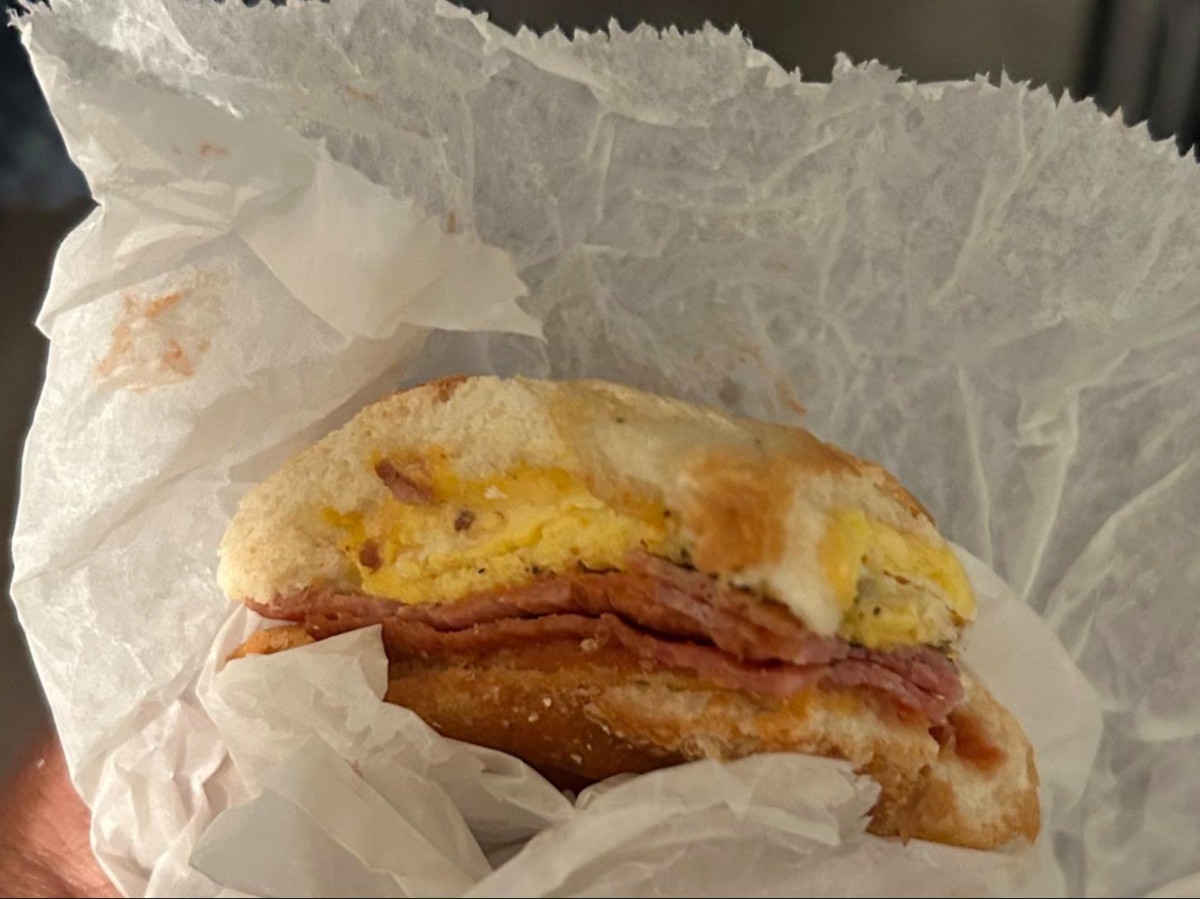 Holding a Taylor ham, egg, and cheese sandwich