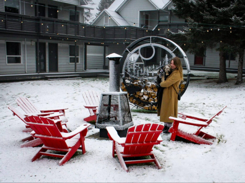 The author Taylor Herperger holding her puppy at the outdoor area of Arrowhead Family Resort in winter