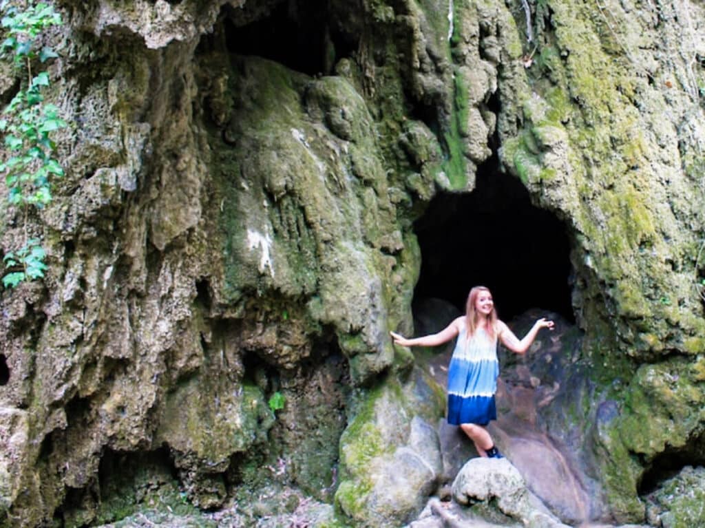 The author Taylor Herperger, posing near the entrance of the cave at Krka National Park