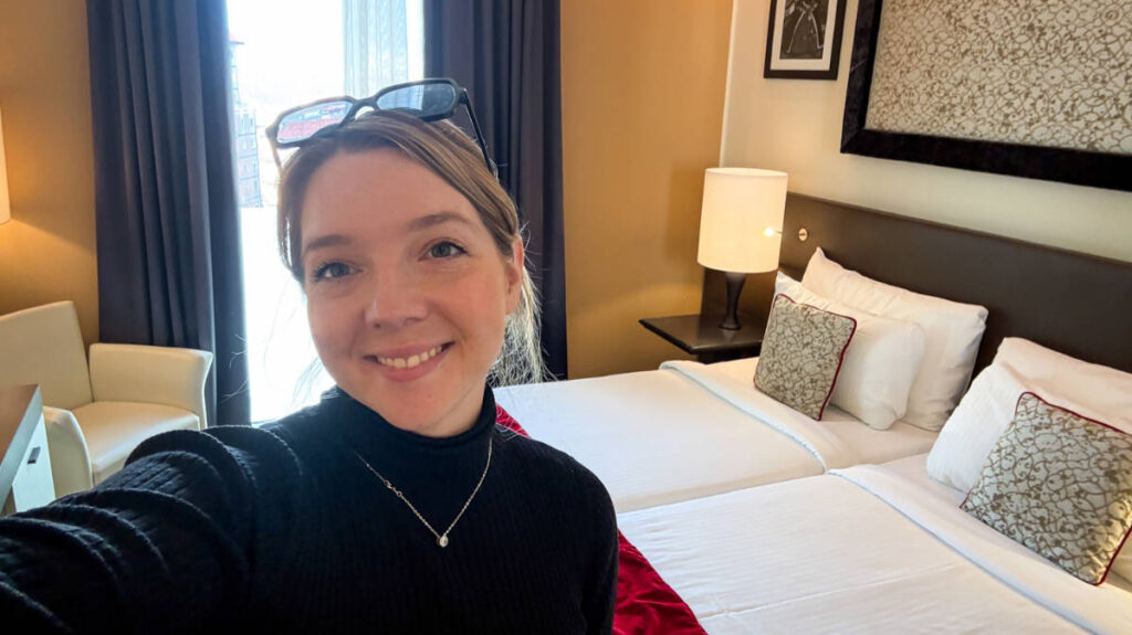 The author, Taylor Herperger smiling for a photo inside her room in Leonardo Royal Hotel