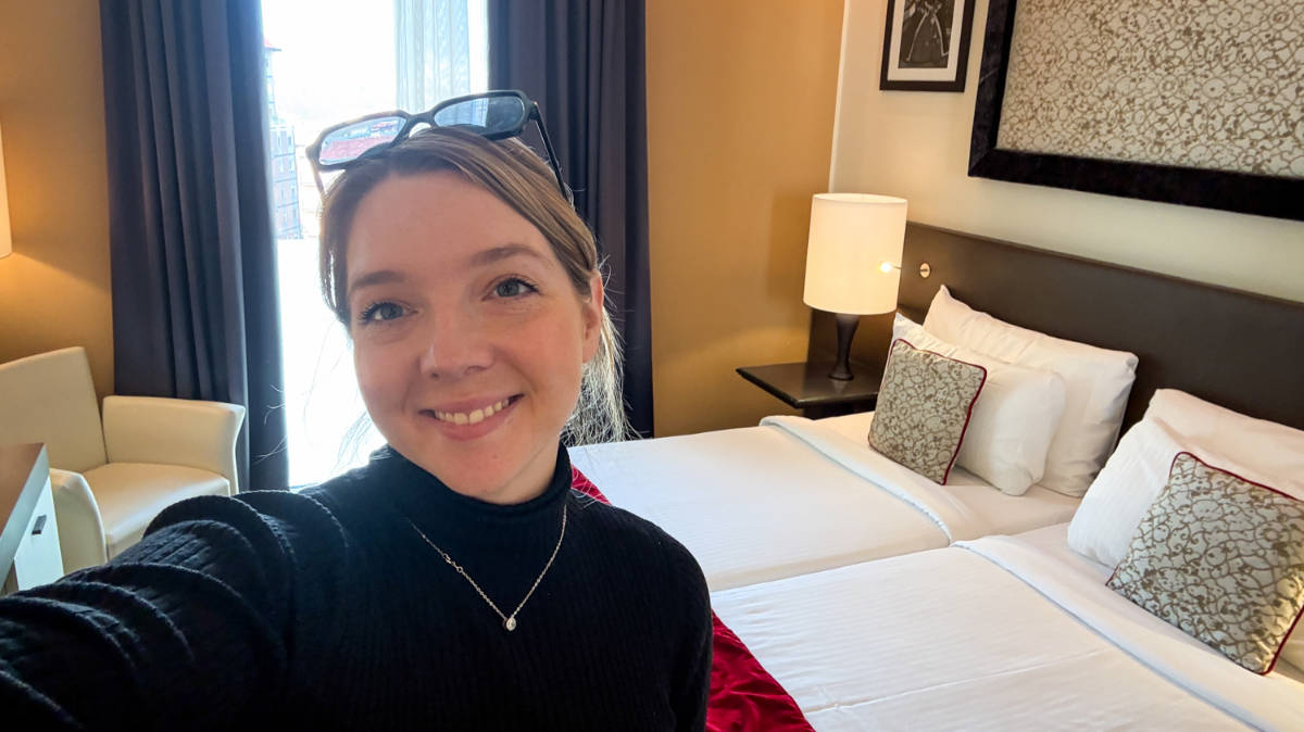 The author, Taylor Herperger smiling for a photo inside her room in Leonardo Royal Hotel
