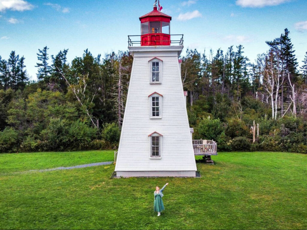 The author Taylor Herperger, posing in front of the lighthouse at Prince Edward Island
