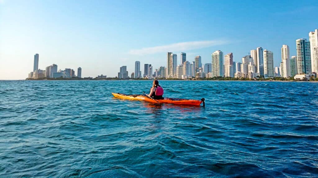 The author Taylor Herperger, kayaking with skyline view in the background in Cartagena