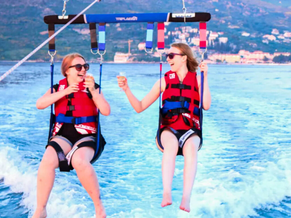 The author Taylor Herperger and her friend Cailee parasailing near Dubrovnik