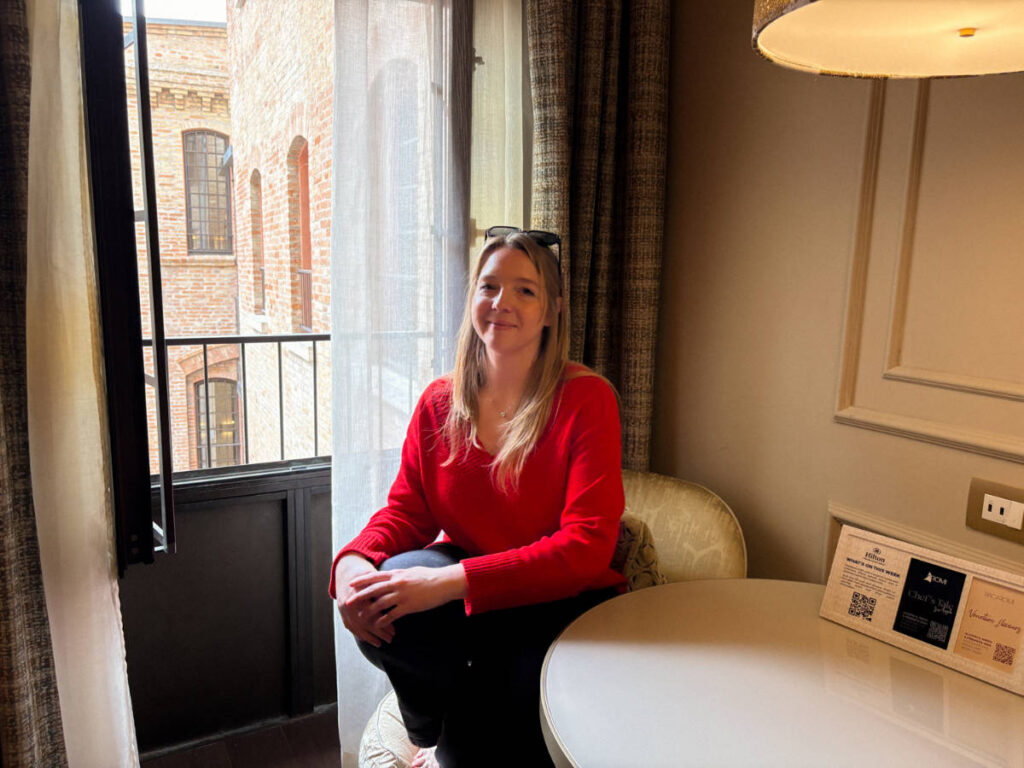 The author Taylor Herperger, sitting by the window overlooking the courtyard