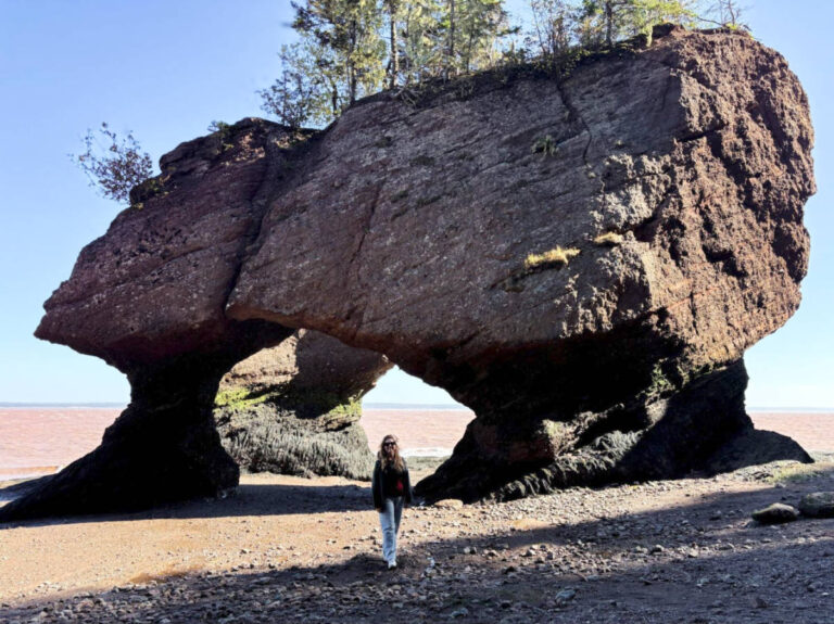 The author Taylor Herperger, posing for a photo at Hopewell Rocks Provincial Park