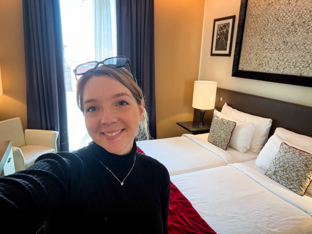 The author, Taylor Herperger smiling for a photo inside her room in Leonardo Royal Hotel
