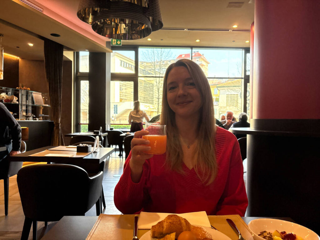 The author, Taylor Herperger holding a glass of juice in Leonardo Royal Hotel Mestre