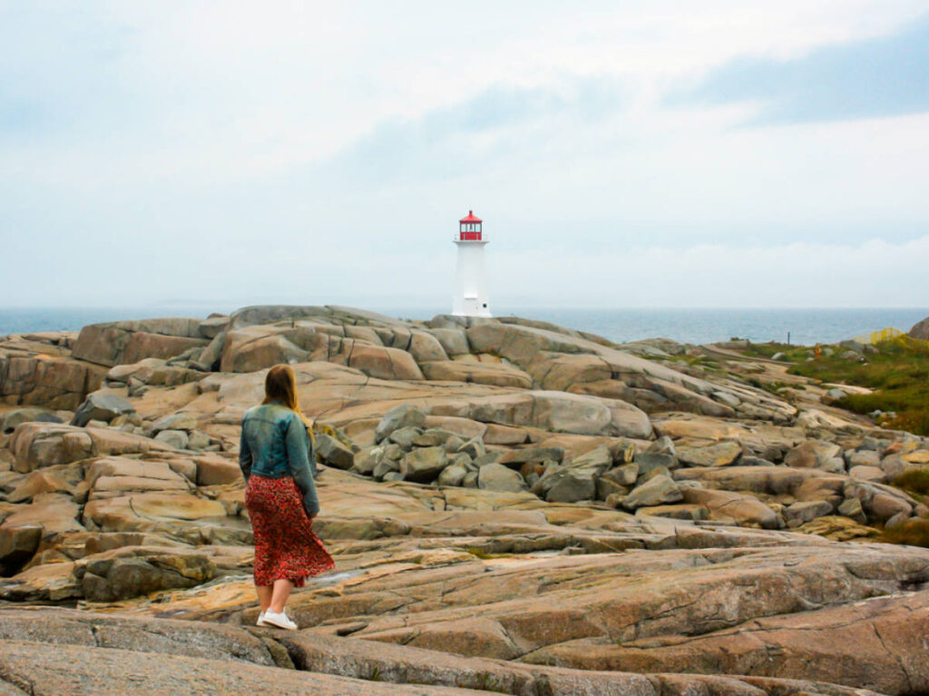 Travel Lemming Editor Taylor Herperger admiring the Peggy’s Cove Lighthouse