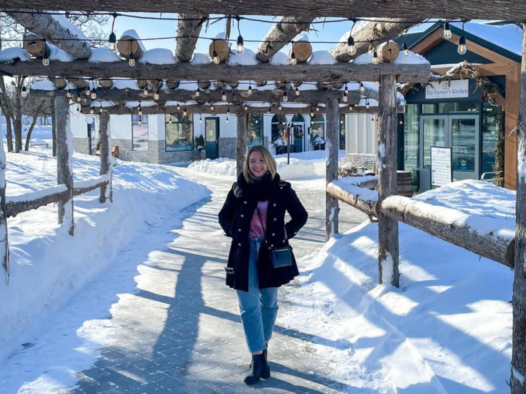 The author Taylor Herperger, posing at the snow covered pathway in Pineridge Hollow