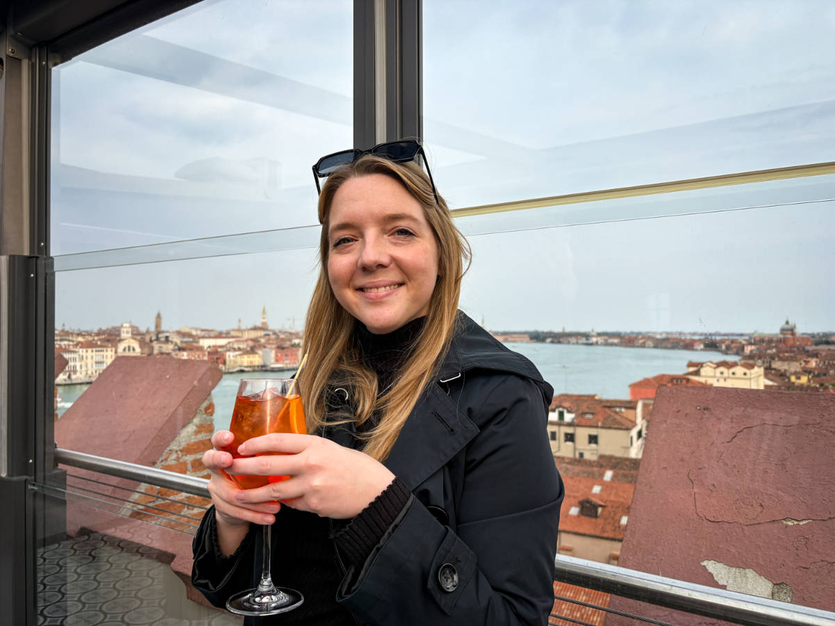 The author Taylor Herperger, enjoying her drink at the Skyline Rooftop Bar