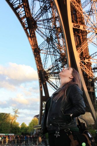Travel Lemming's Senior Editor Taylor posing for a photo under the Eiffel Tower
