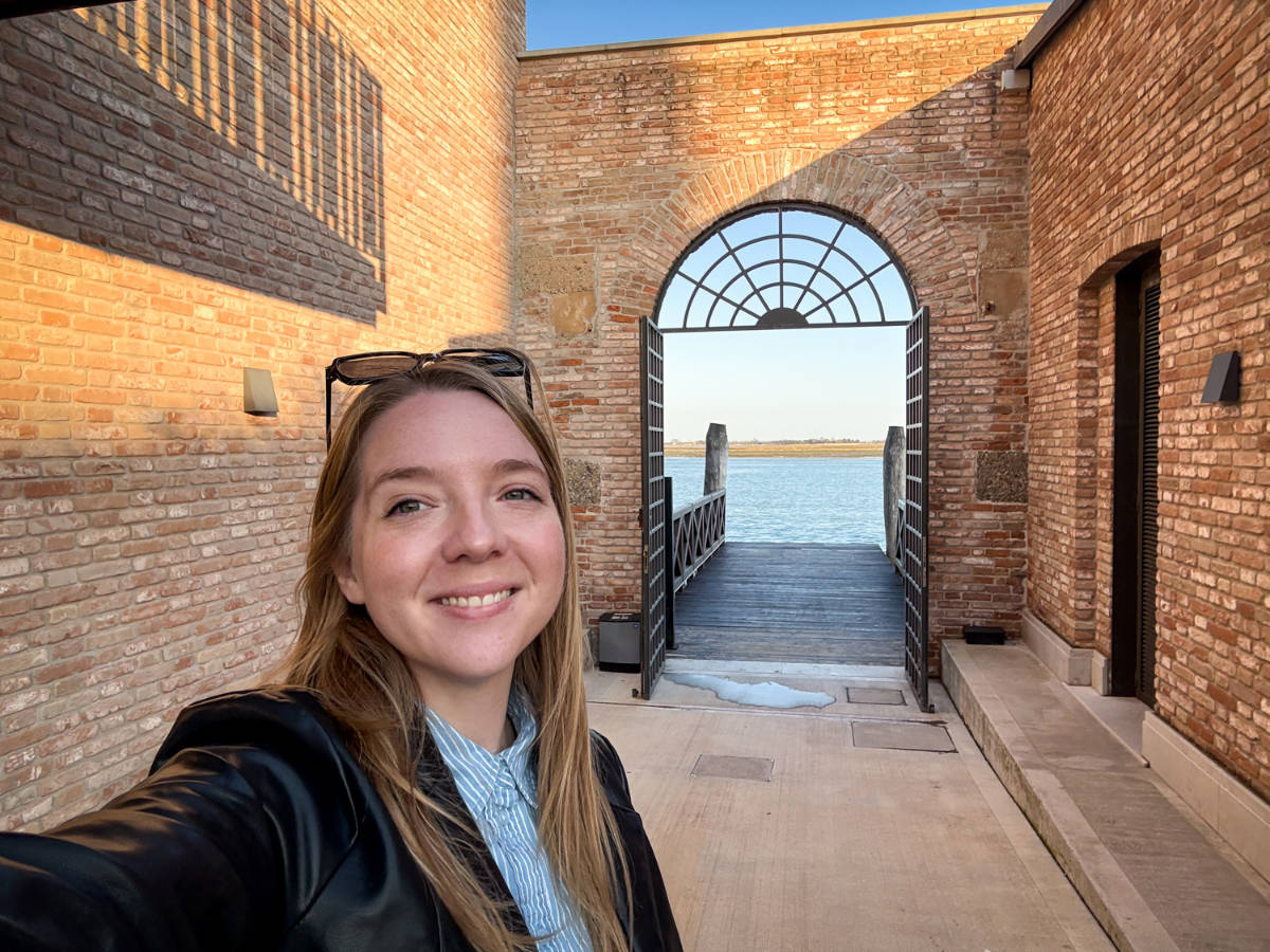 The author Taylor Herperger, smiling for a photo at the hotels’ water taxi dock