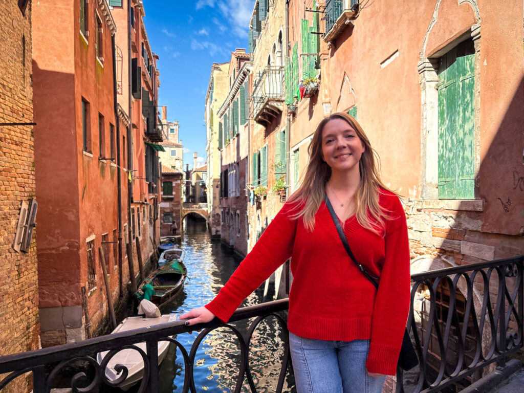 The author Taylor Herperger, standing on the bridge with an overlooking view of the canal in San Polo