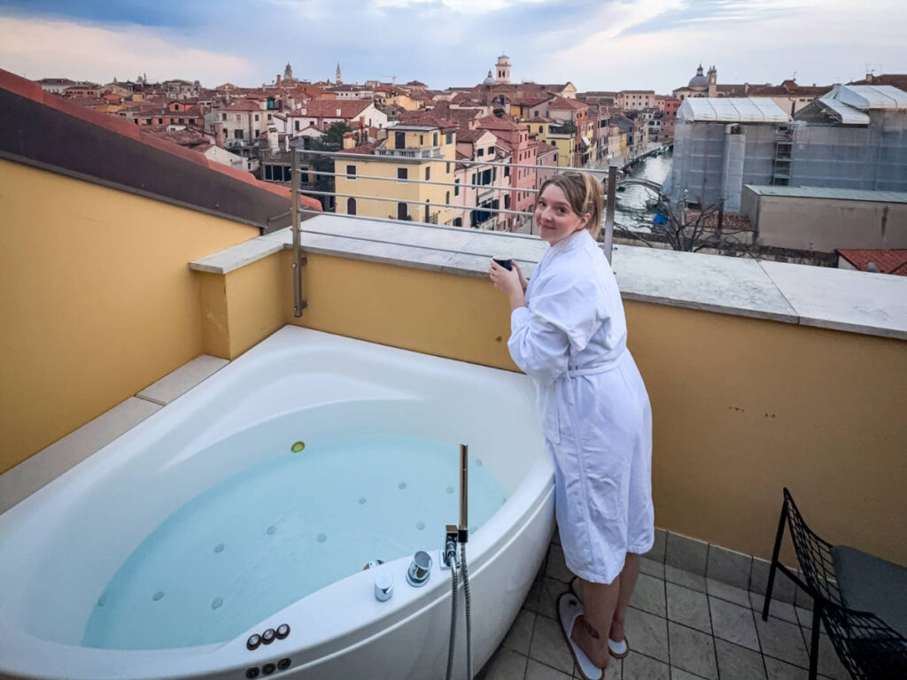 The author Taylor Herperger, drinking her tea by the outdoor jacuzzi in Palazzo Veneziano