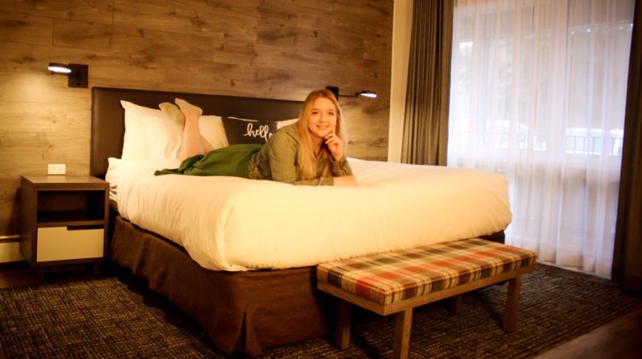 The author Taylor Herperger posing for a picture on the hotel bed