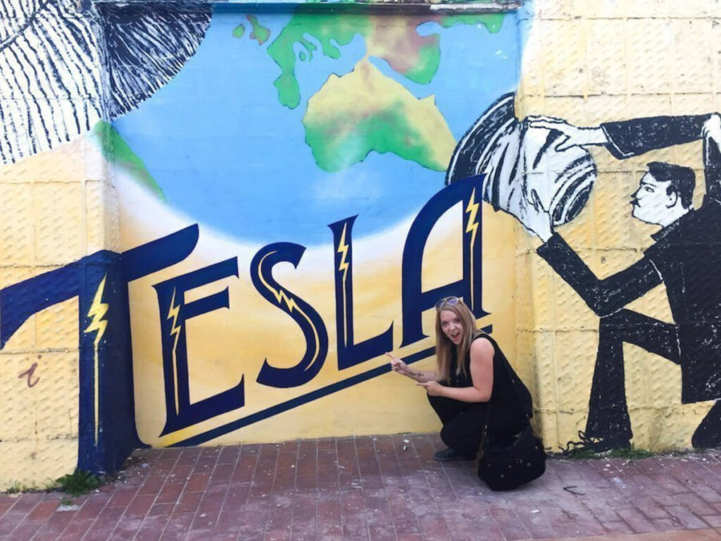 The author Taylor Herperger shoeing the Tesla mural in Zagreb