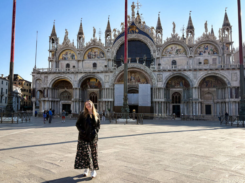 The author Taylor Herperger, posing for a photo in front of the Saint Mark's Basilica