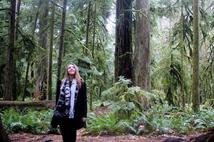 Taylor stands among the rainforest on Vancouver Island, British Columbia Canada