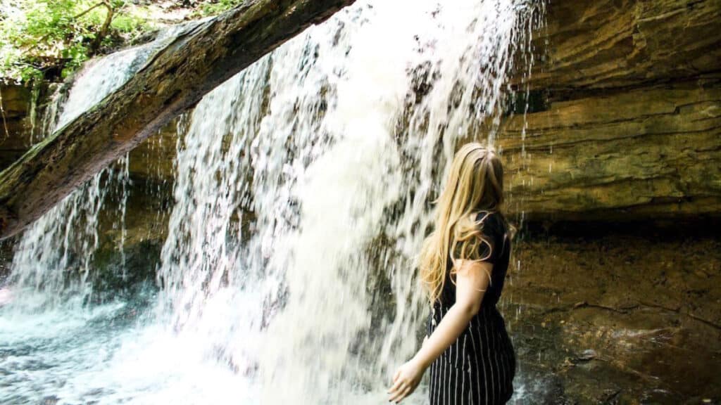 The author Taylor Herperger, facing the waterfall near Louisville, Kentucky