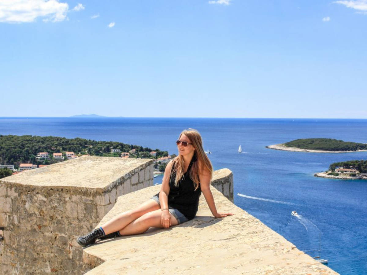 The author Taylor Herperger sits on the walls of the Spanjola Fortress in Hvar