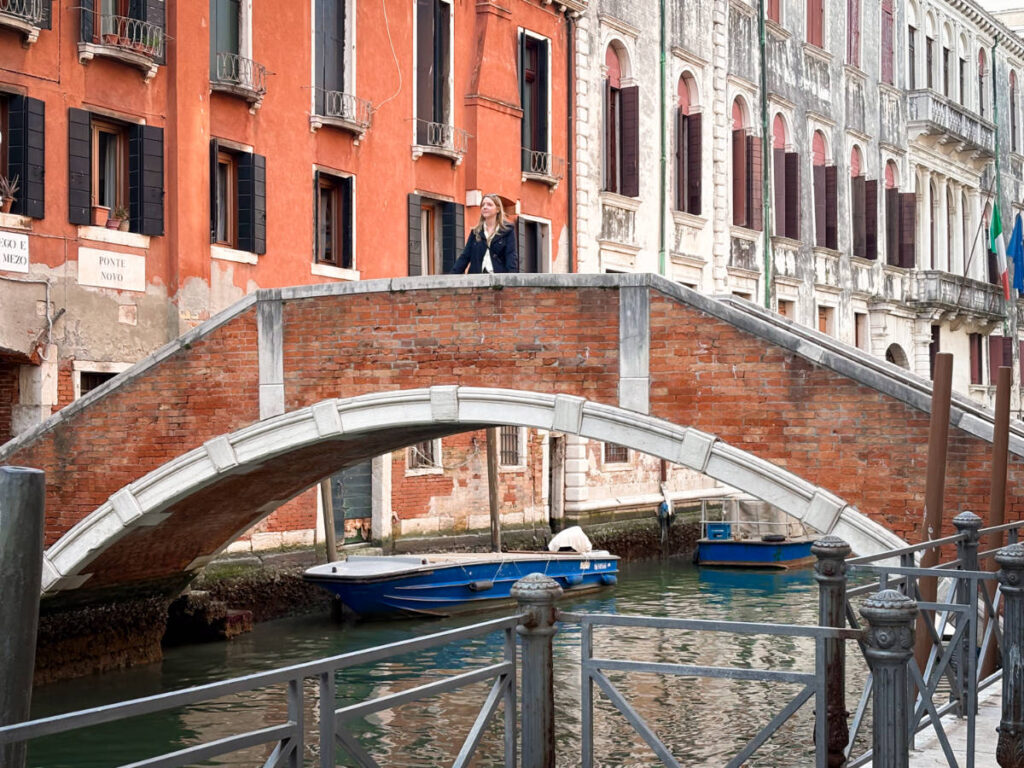 The author Taylor Herperger, standing on the brick bridge in Castello
