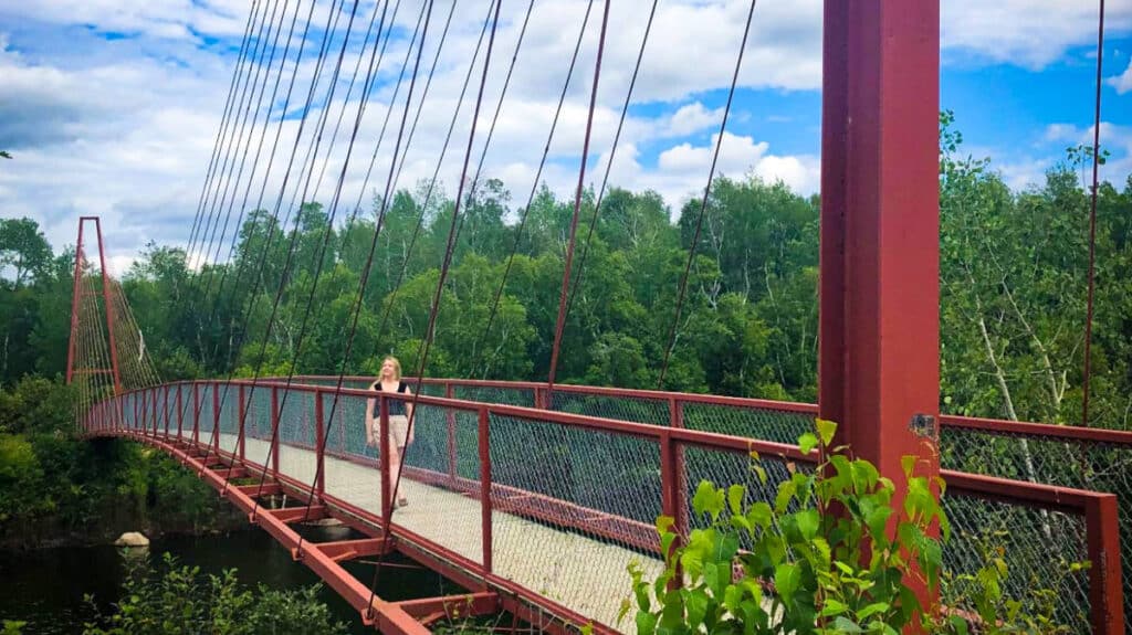 The author Taylor Herperger, walking along the Whiteshell River Suspension Bridge