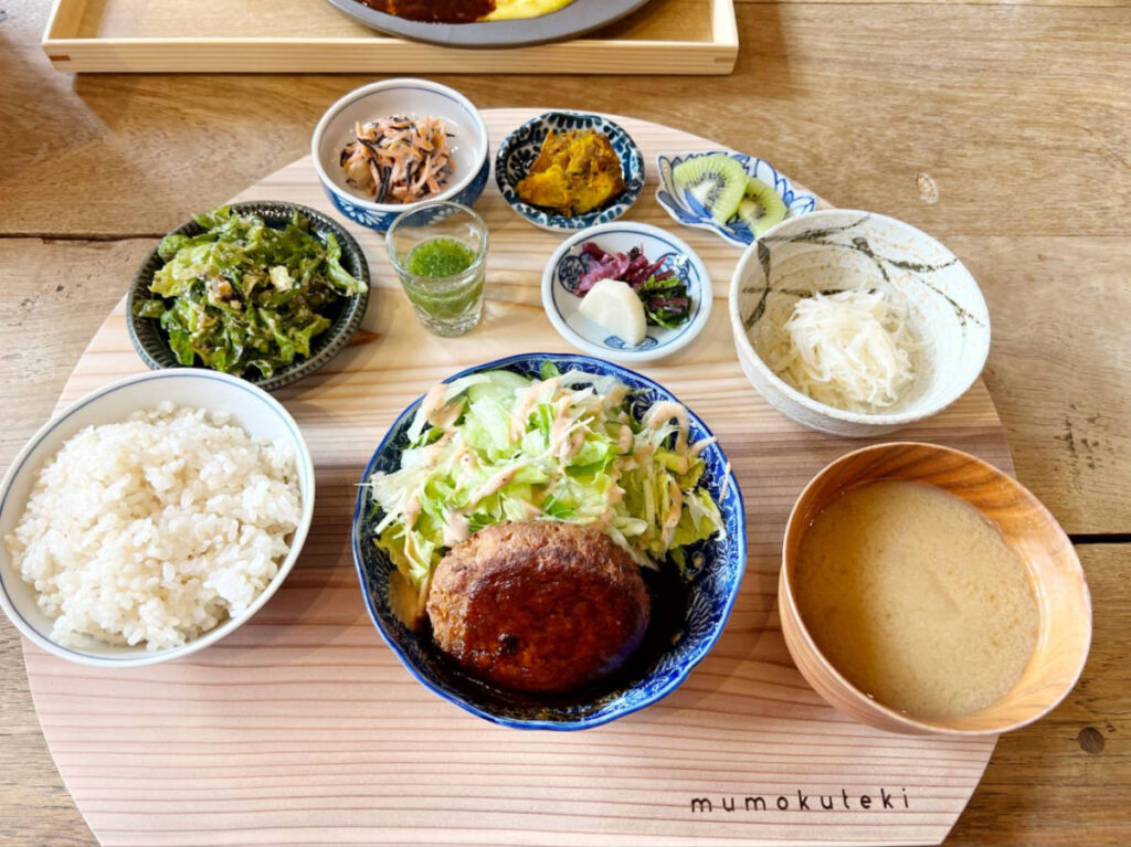 A tofu hamburger set with side dishes on the side