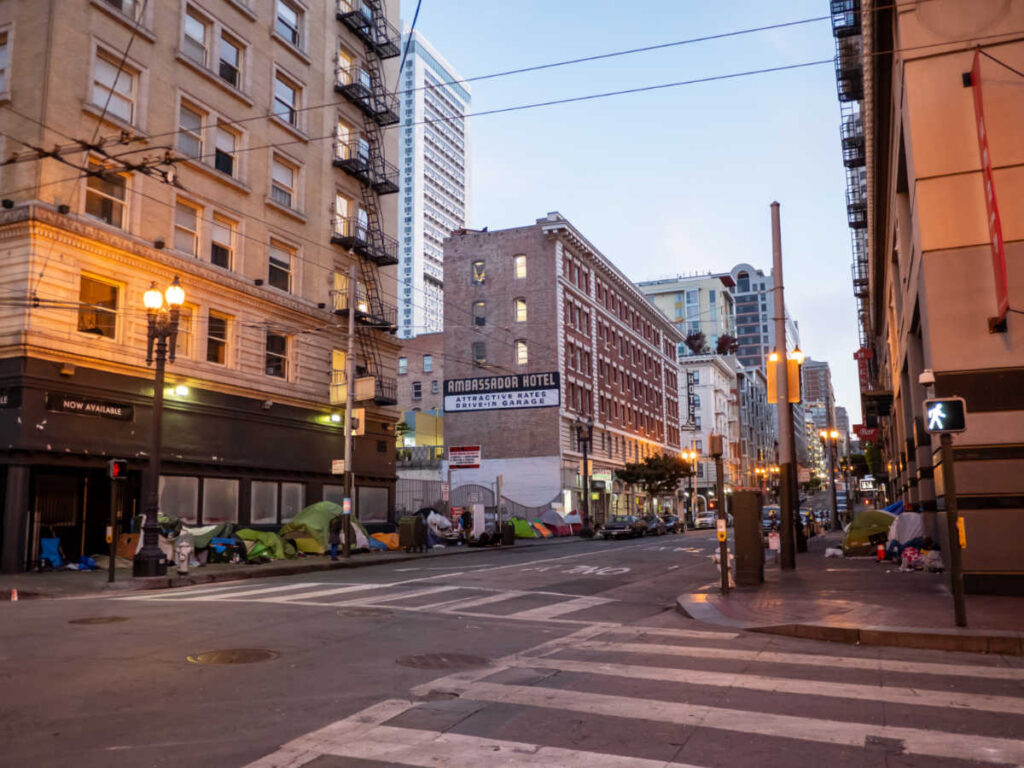 View of the pop up tents and homeless along the sidewalk in Tenderloin at night