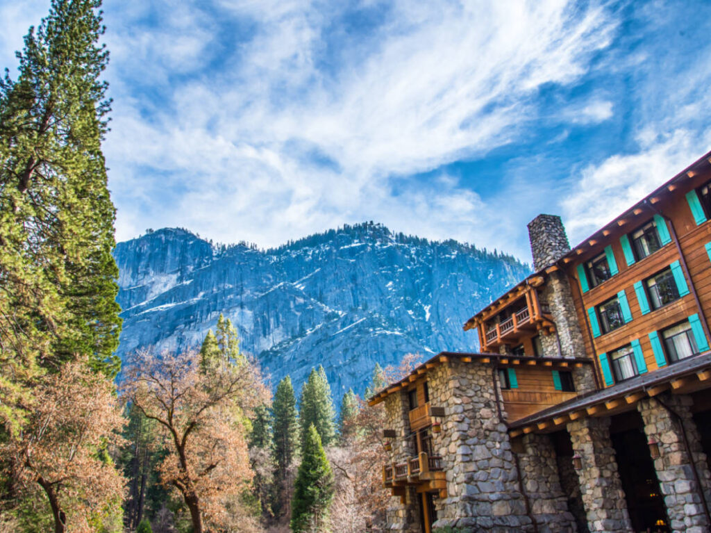 Exterior view of The Ahwahnee Hotel with a magnificent view in the background