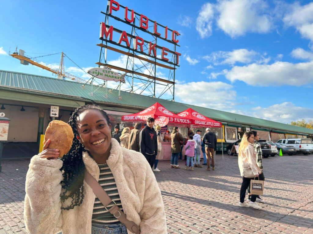 Author Chelsea showing a big cookie at Pike Place Market