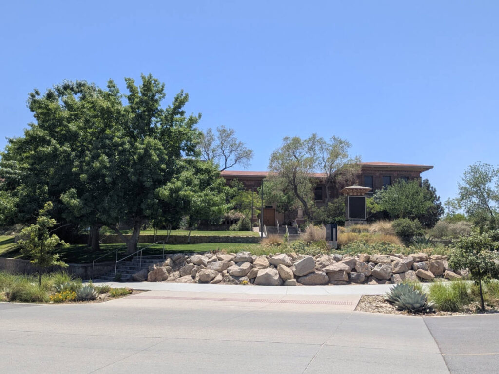 View of the entrance to The Centennial Museum surrounded by greeneries