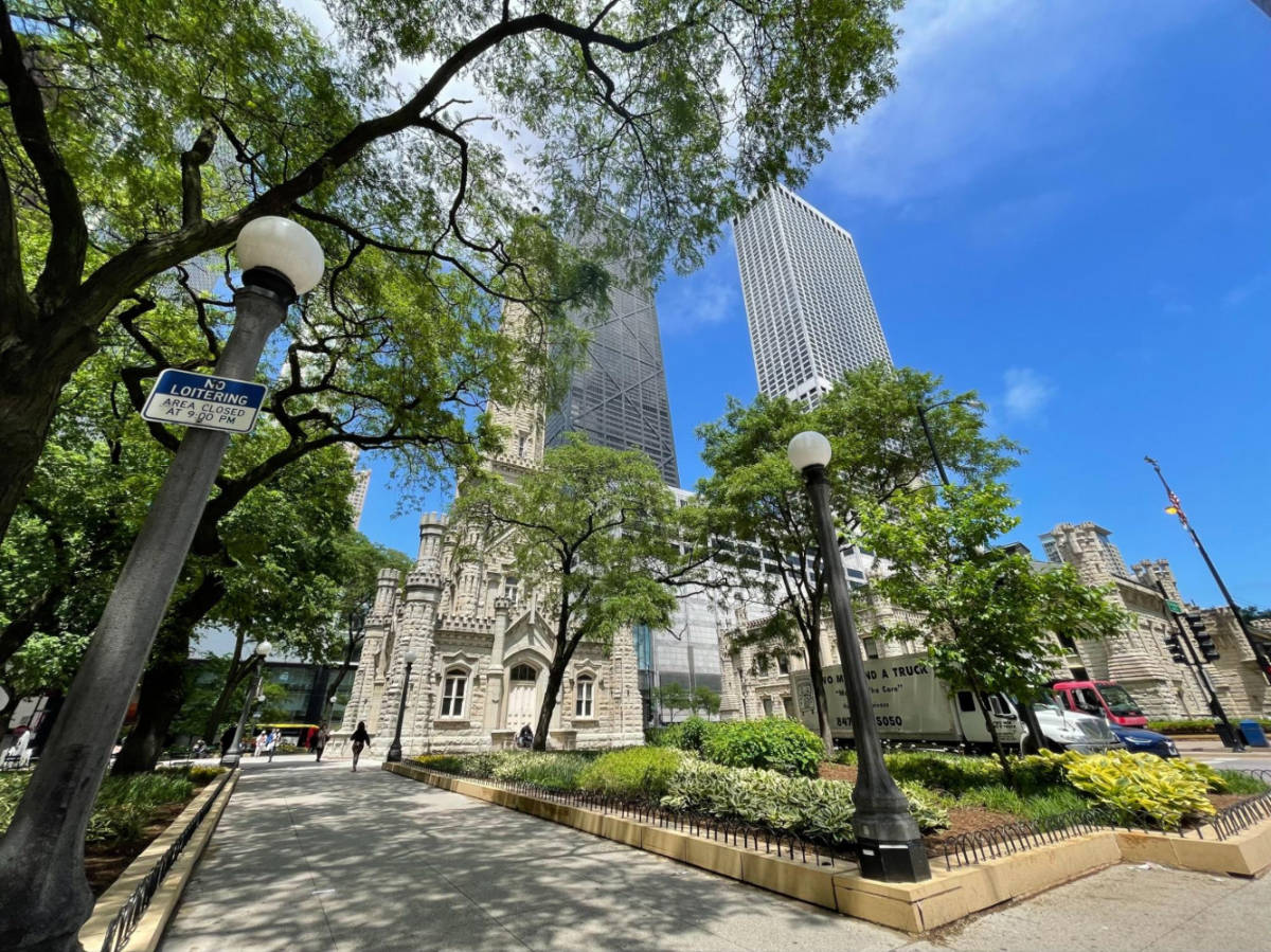 Perspective view of The Chicago Water Tower and greenery around on a sunny day