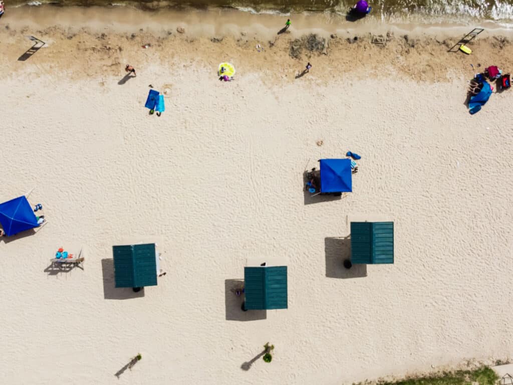 Aerial view of the beach umbrellas in the white sand of The City Beach