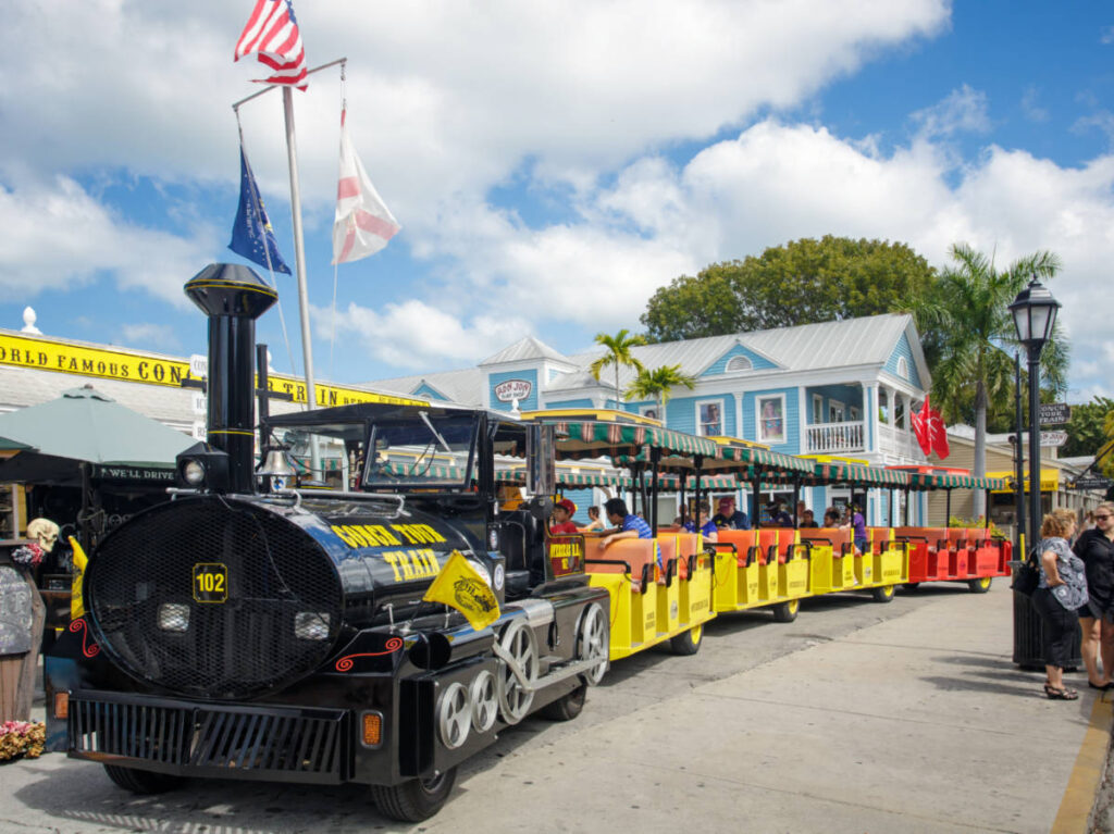 The crowd outside the colorful exterior of The Conch Train