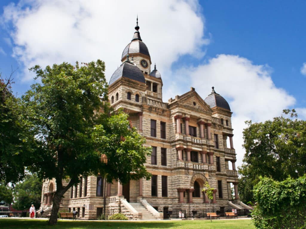 Exterior view of the Denton County Courthouse surrounded by greenery