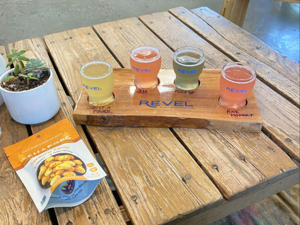 A tray of Colorful assortment of kombucha drinks at Revel Kombucha Bar.