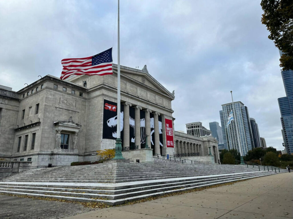 Exterior view of The Field Museum and the half-mast US flag in front