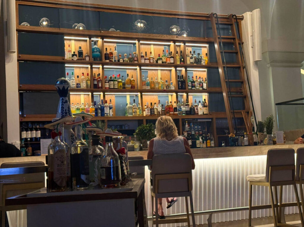 A man sitting in front of the bar counter in The Great Room Lobby Bar