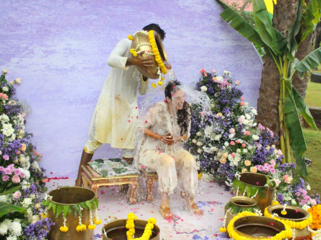 Dumping vase of water on the bride for the Haldi ceremony