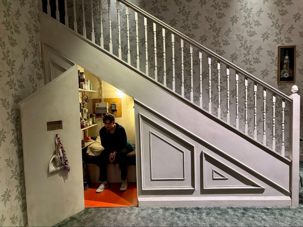 Michael sitting inside the Harry Potter staircase