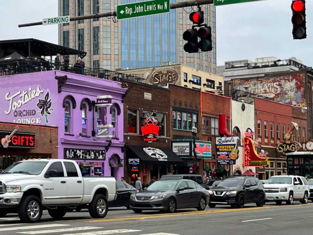 View of the shops and cars passing by along The Honky Tonk Highway