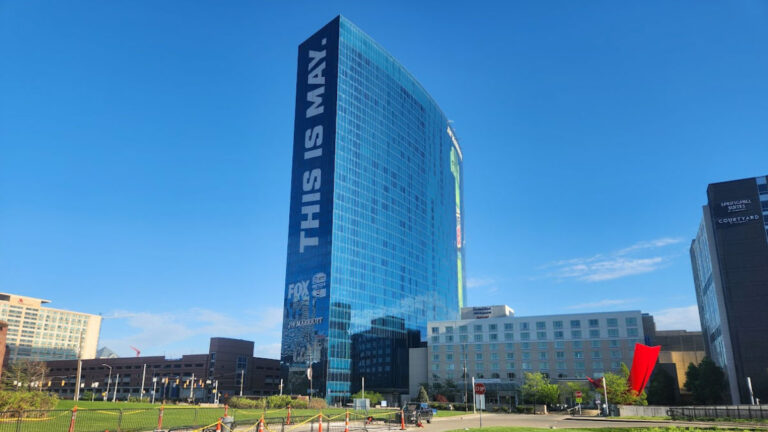 View of JW Marriott Indianapolis skyscraper with a large THIS IS MAY graphic on its facade
