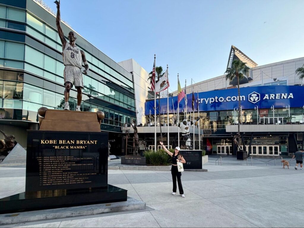 Author Betty beside the Kobe statue at crypto arena