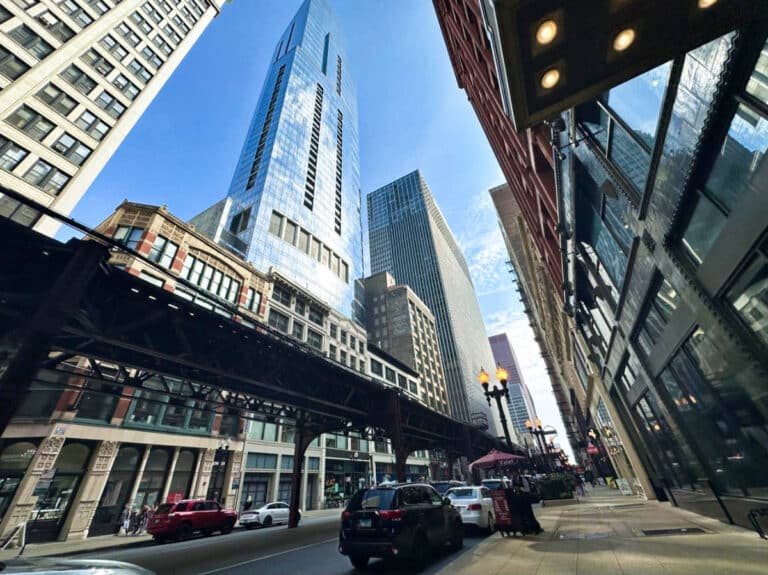View of the busy street, train line and skyscrapers in Chicago